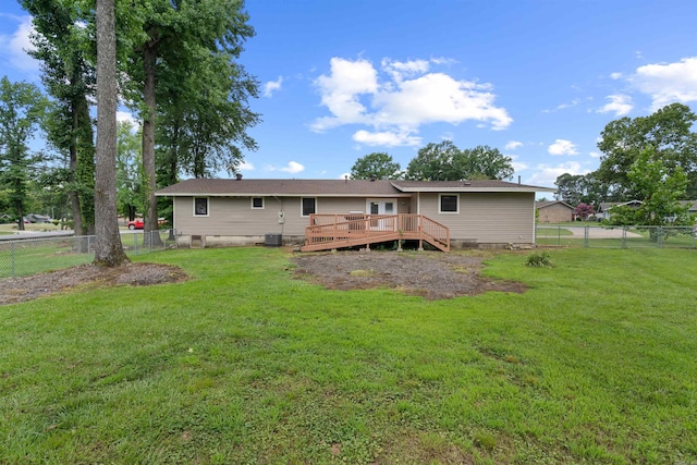 back of property featuring a yard and a deck