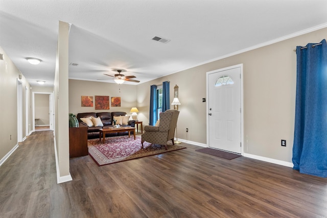 living room featuring ornamental molding, ceiling fan, and dark hardwood / wood-style floors