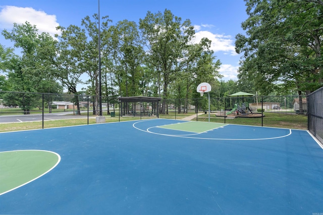 view of basketball court with a playground