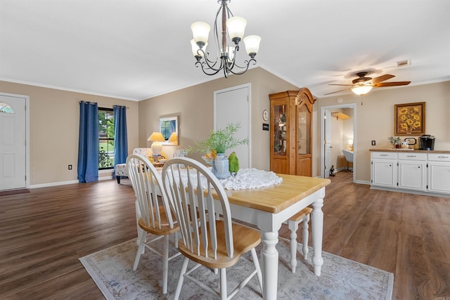 dining area with ceiling fan with notable chandelier, dark wood-type flooring, and crown molding