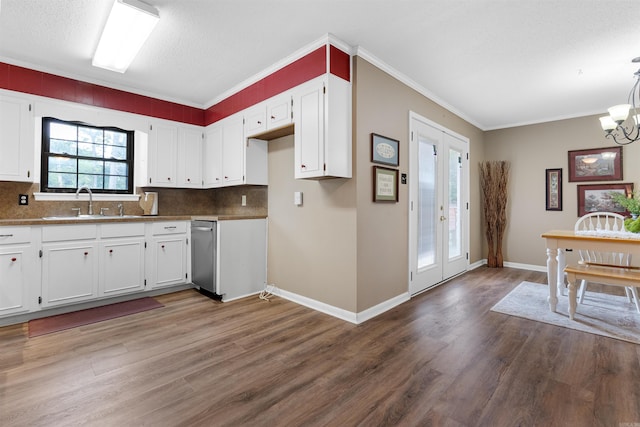 kitchen featuring dark wood-type flooring, white cabinetry, french doors, and crown molding