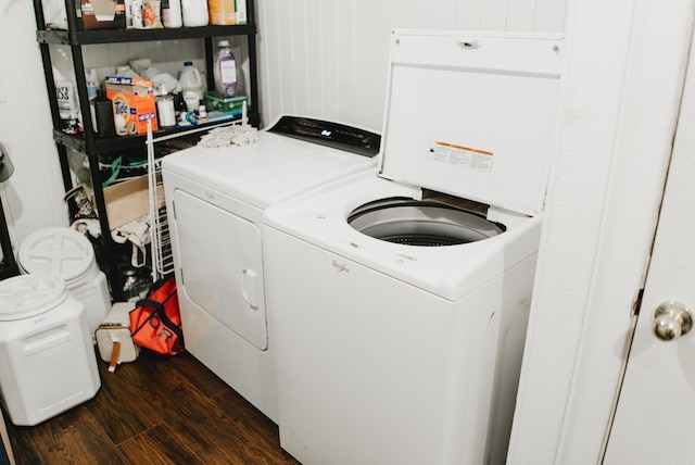 laundry room with washer and clothes dryer and dark hardwood / wood-style floors