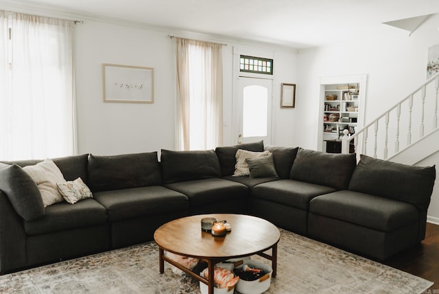 living room with hardwood / wood-style flooring and crown molding