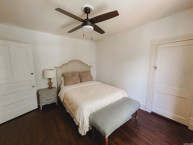 bedroom with ceiling fan and dark hardwood / wood-style flooring