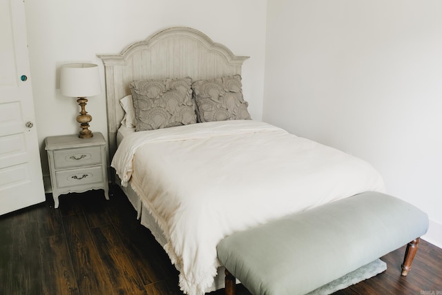 bedroom with dark hardwood / wood-style floors