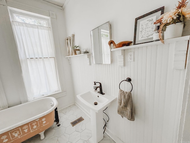 bathroom featuring a bathtub and ornamental molding