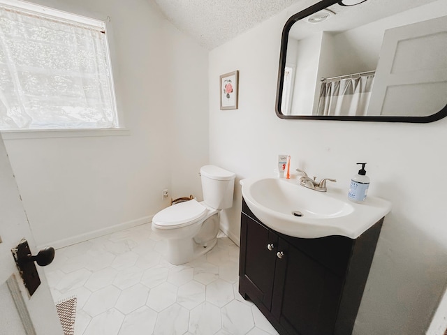 bathroom with toilet, vaulted ceiling, tile patterned flooring, a textured ceiling, and vanity