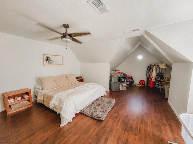 bedroom featuring a textured ceiling, dark wood-type flooring, ceiling fan, and vaulted ceiling