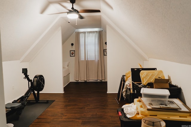 additional living space with dark hardwood / wood-style flooring, ceiling fan, a textured ceiling, and vaulted ceiling