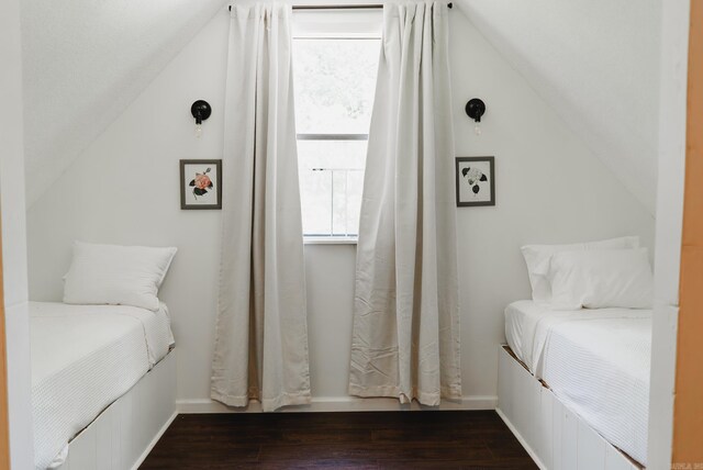 bedroom featuring wood-type flooring and vaulted ceiling