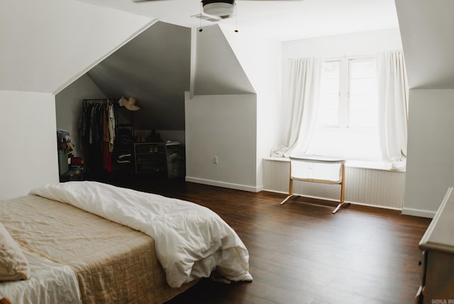 bedroom featuring dark wood-type flooring, ceiling fan, and vaulted ceiling