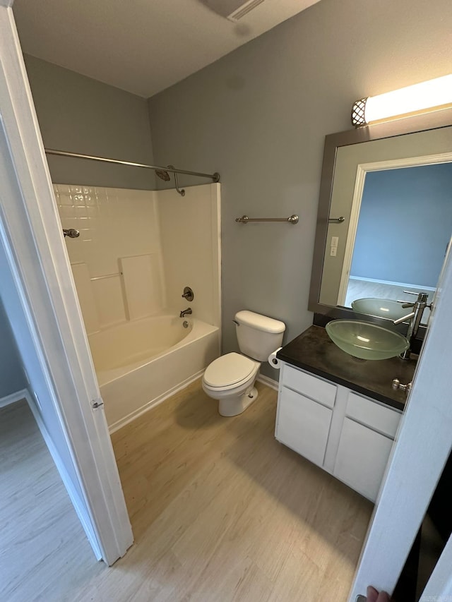 full bathroom with toilet, shower / bathing tub combination, vanity, and hardwood / wood-style floors