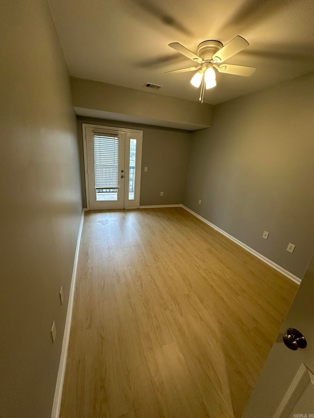 empty room with light wood-type flooring and ceiling fan