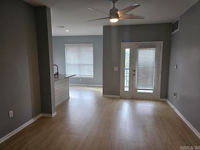 interior space with light wood-type flooring and ceiling fan