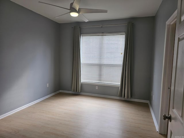 spare room featuring light wood-type flooring and ceiling fan