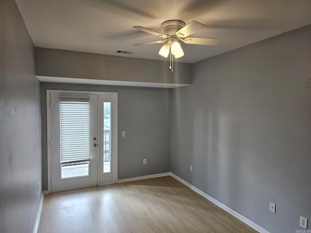 empty room featuring ceiling fan and light wood-type flooring