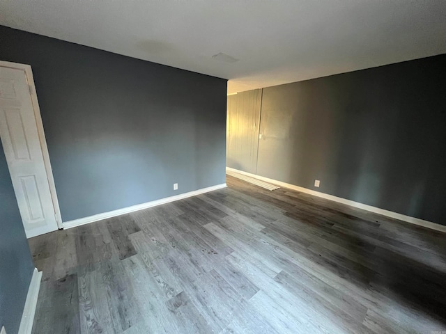 empty room with hardwood / wood-style floors