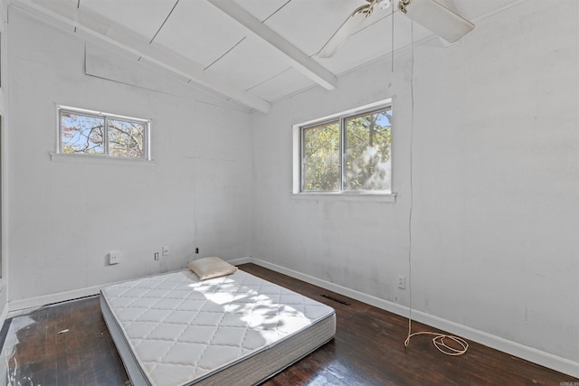 bedroom featuring lofted ceiling with beams, dark wood-type flooring, multiple windows, and ceiling fan