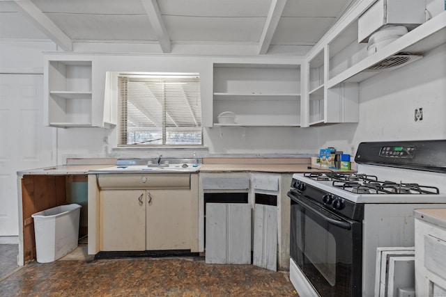 kitchen featuring gas range gas stove, sink, and beam ceiling