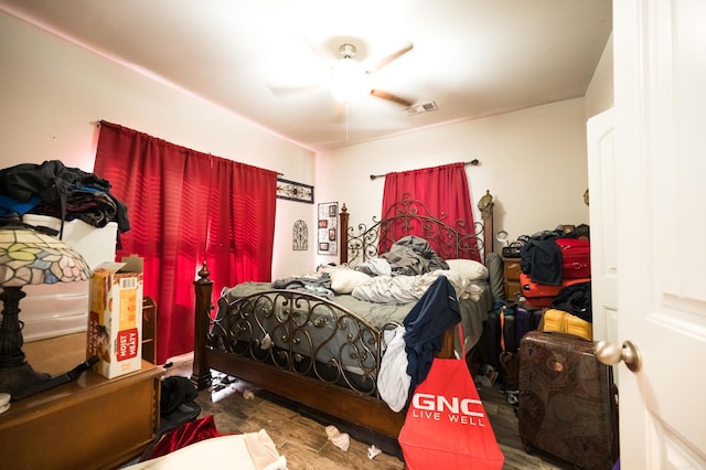 bedroom featuring dark hardwood / wood-style flooring and ceiling fan