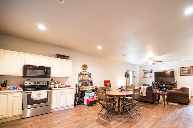 kitchen featuring stainless steel electric stove, ceiling fan, white cabinetry, and light hardwood / wood-style flooring