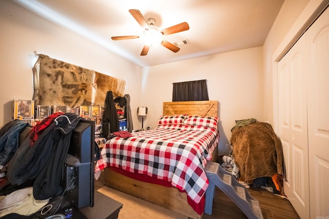 bedroom featuring hardwood / wood-style flooring, ceiling fan, and a closet