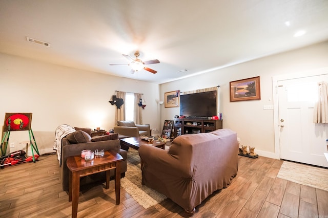 living room with ceiling fan and light hardwood / wood-style floors