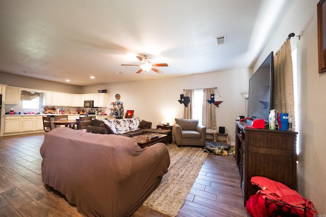 living room featuring hardwood / wood-style flooring and ceiling fan