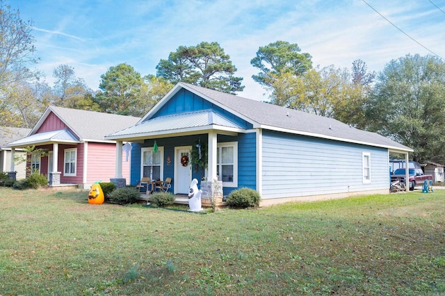 view of front of home with a front yard and covered porch