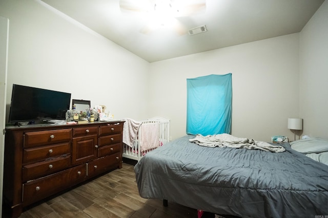 bedroom featuring dark hardwood / wood-style flooring and ceiling fan