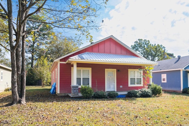 view of front of house with a porch and a front yard