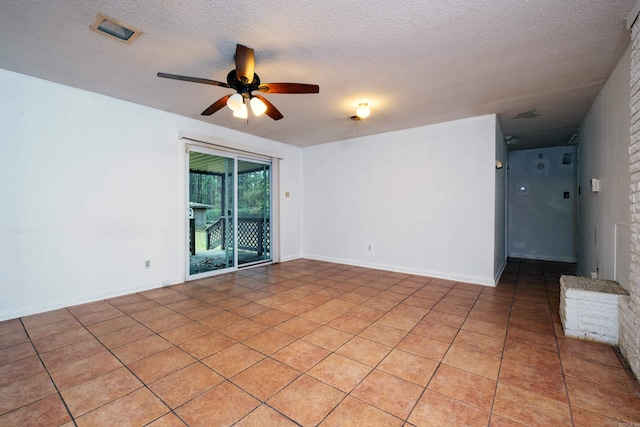 spare room with light tile patterned flooring, a textured ceiling, and ceiling fan