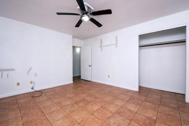 unfurnished bedroom featuring light tile patterned floors, ceiling fan, and a closet