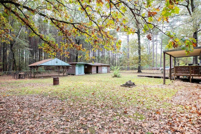 view of yard featuring an outdoor fire pit and an outdoor structure