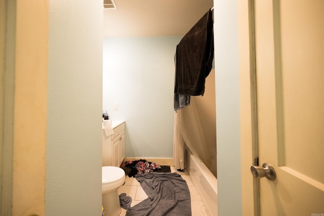 bathroom with tile patterned flooring, vanity, and toilet