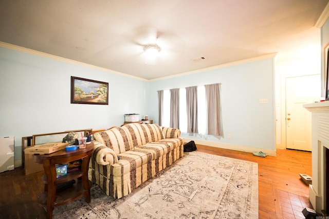 living room with hardwood / wood-style flooring and crown molding