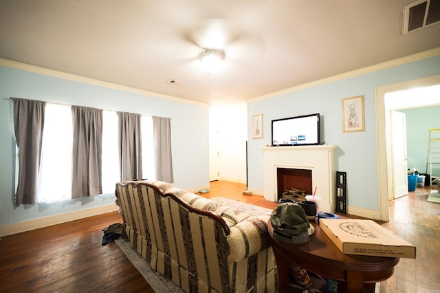 living room featuring wood-type flooring and crown molding