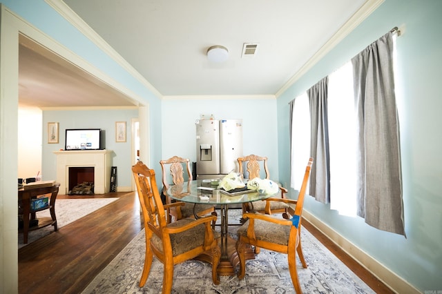 dining room featuring dark hardwood / wood-style flooring and ornamental molding