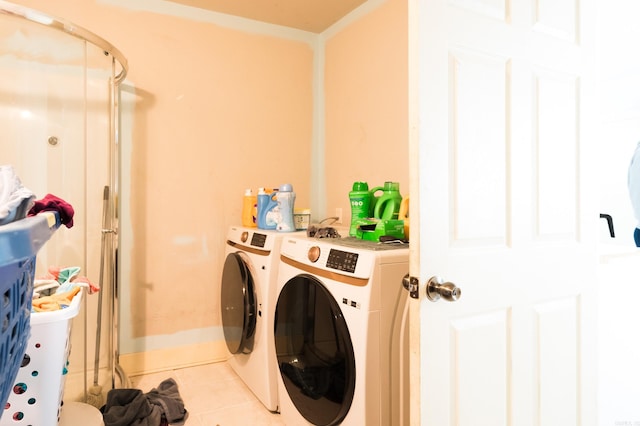 clothes washing area with light tile patterned floors and separate washer and dryer