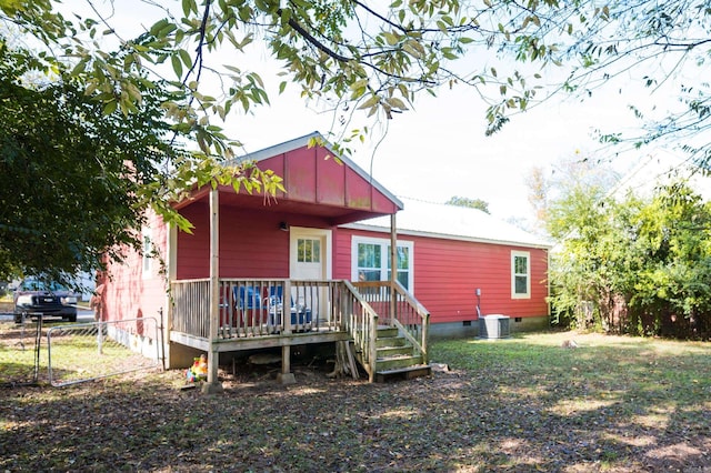 rear view of house featuring central AC