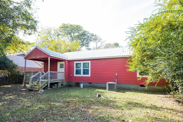 back of property featuring a lawn