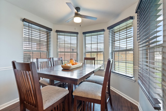 dining space featuring dark wood-type flooring, a wealth of natural light, and ceiling fan