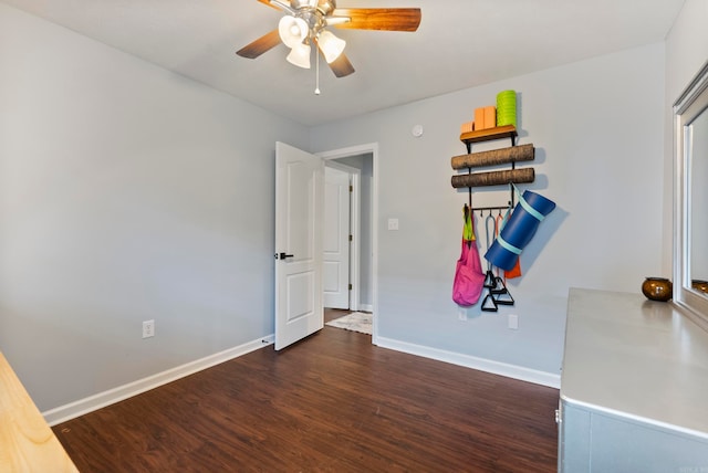 empty room with ceiling fan and dark hardwood / wood-style flooring