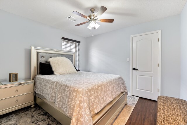 bedroom with ceiling fan and dark hardwood / wood-style flooring