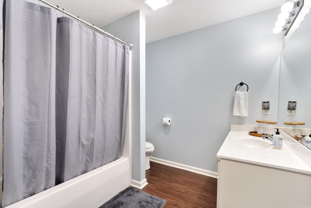 full bathroom featuring wood-type flooring, vanity, a textured ceiling, toilet, and shower / bathtub combination with curtain