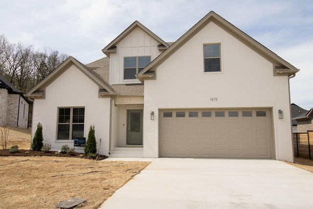 view of front of house featuring driveway, a garage, a shingled roof, board and batten siding, and brick siding