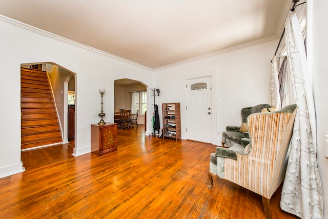 sitting room with hardwood / wood-style flooring and crown molding