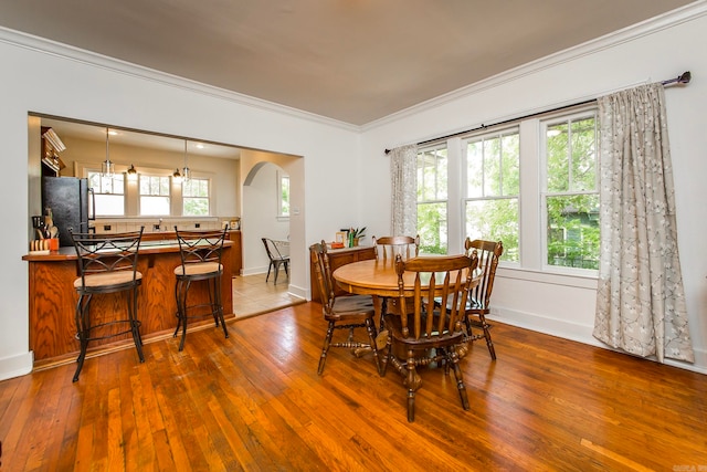 dining room with a chandelier, hardwood / wood-style floors, and ornamental molding