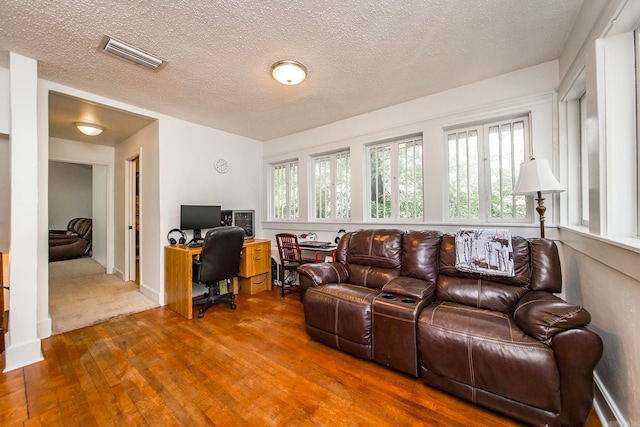 living room featuring hardwood / wood-style floors and a textured ceiling