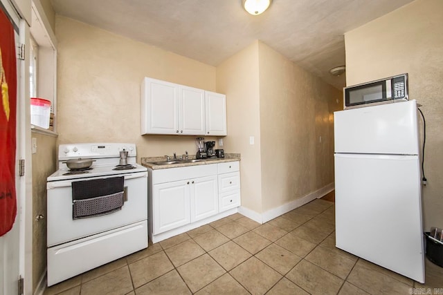 kitchen with white cabinetry, white appliances, sink, and light tile patterned floors